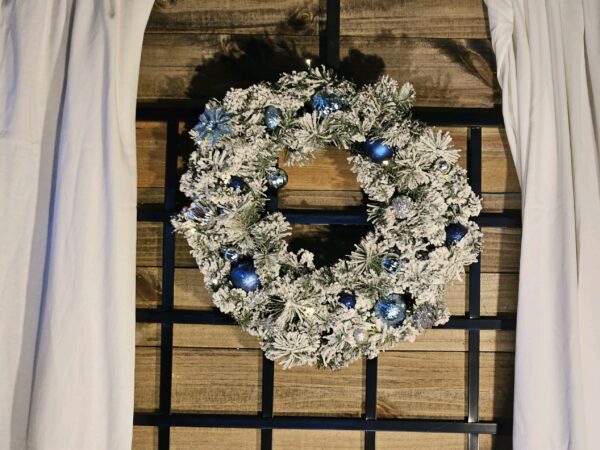 A wreath of flowers hanging on the wall.