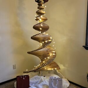 A large spiral christmas tree with lights in the middle.