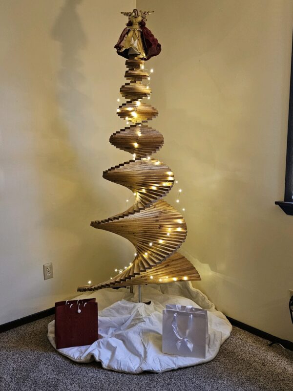 A large spiral christmas tree with lights in the middle.