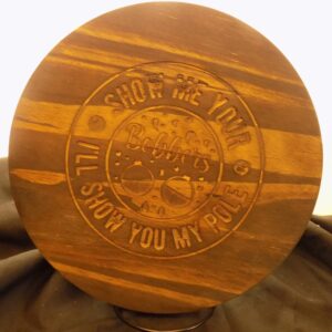 A wooden plate with the words " shop me your self, i 'll show you my pole ".