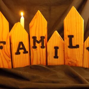 A candle is lit on the family sign.