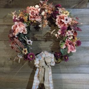 A wreath of flowers hanging on the wall.