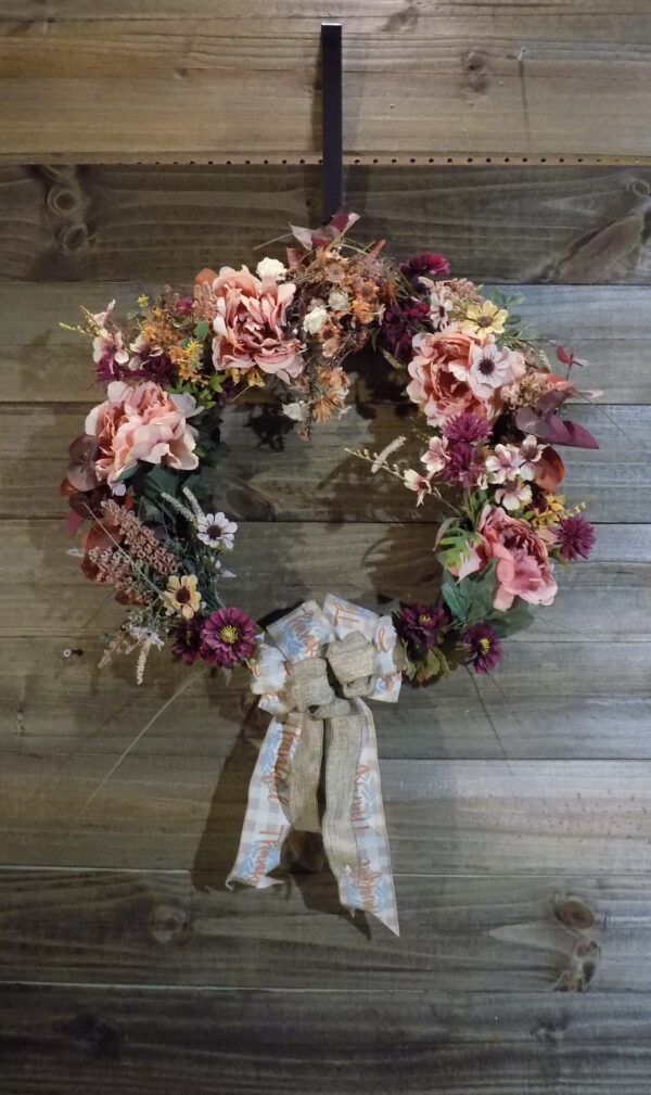 A wreath of flowers hanging on the wall.